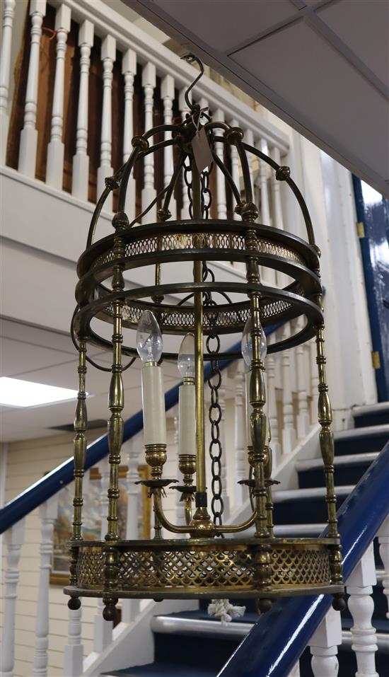 A brass hall lantern of cylindrical form fitted three candle lights, H approx 70cm Dia 37cm